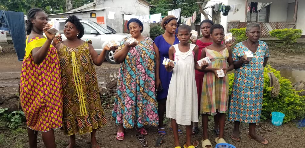 IYEC distributing antiseptic soapa to women to fight against Covid 19